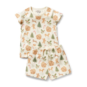 Children's pajama set with gingerbread man and tree pattern on a white background