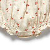 Baby romper with red floral pattern on a white background