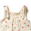 Beige baby dress with red floral patterns on a white background