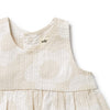 Close-up of a beige baby dress with a brand logo on a white background
