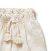 Beige textured fabric with tassels on a white background