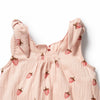 Pink baby dress with strawberry pattern on a white background