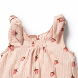 Pink baby dress with strawberry pattern on a white background
