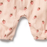 Baby bloomers with strawberry pattern on a light pink background