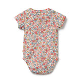 Floral patterned baby onesie on a white background