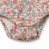 Floral-patterned baby romper on a white background