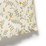 Floral patterned fabric with yellow flowers and green leaves on a white background