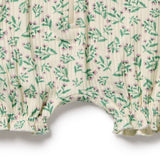 Floral-patterned fabric with green leaves and pink flowers on a white background