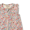 Floral patterned baby garment with brand label on a white background