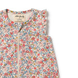 Floral patterned baby garment with brand label on a white background