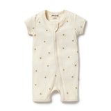 Baby romper with gold floral patterns on a white background