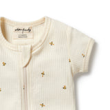 Baby romper with gold bee patterns on a white background