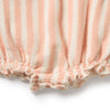 Close-up of pink and white striped fabric with a textured surface on a white background