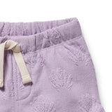 Close-up of purple textured pants with a white drawstring on a white background
