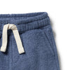 Blue fleece pants with a white drawstring on a light gray background