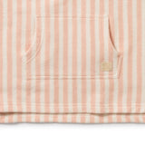 Close-up of a pink and white striped fabric with a brand logo on a white background