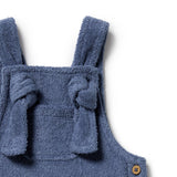 Blue baby romper with ruffled details on a white background