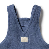 Blue children's apron with a visible brand label on a white background