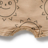 Beige baby romper with smiley face design on a white background