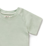 Light green t-shirt with a brand label on a white background