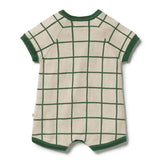 A short-sleeve knit romper in cream with a green windowpane grid pattern and dark green ribbed trim, shown flat on a white background.