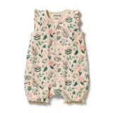 A sleeveless cream-colored baby romper with a green and pink floral print, featuring ruffled shoulder straps and a snap-button front, shown on a white background.