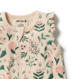 Close-up of a ribbed knit top with a floral print in pink and green on a cream background, featuring ruffled shoulder details and a round neckline.