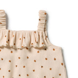 Close-up of a ribbed knit top in a light cream-beige color with a small brown and orange floral pattern, featuring a ruffled neckline and gathered shoulder straps, shown on a plain white background.
