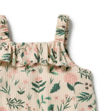 Close-up of a ribbed cotton top with a ruffled neckline and shoulder straps, featuring a green and pink floral print on a cream background.