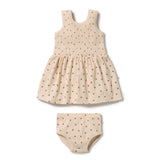 A two-piece baby outfit set consisting of a sleeveless dress and matching diaper cover, both in a cream-colored ribbed fabric with a small brown polka dot pattern, shown on a plain white background.