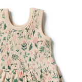 Close-up of a sleeveless baby dress with a textured crinkle fabric, featuring a cream base with a green and pink floral print, set against a plain white background.