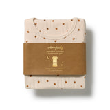 A folded organic cotton sleepwear set by Wilton + Friends, featuring a cream-colored ribbed top and matching bottoms with small brown teddy bear prints, wrapped in a brown paper band.