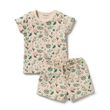A two-piece baby outfit set consisting of a short-sleeve top and matching shorts in a cream-colored waffle fabric with an all-over green leaf and pink floral print, shown on a plain white background.