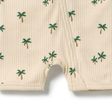 Close-up of a ribbed cream-colored garment, likely a baby romper or footmuff, featuring a small green palm tree pattern and a center zipper.