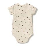 A short-sleeve cream-colored ribbed bodysuit with a small brown paw print pattern, shown flat against a white background.