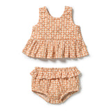 A two-piece baby girl's outfit set featuring a sleeveless ruffle hem top and matching ruffled bloomers, both in a light orange and white gingham pattern with small red embroidered lettering.