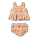 A two-piece baby girl's outfit set featuring a sleeveless ruffled top and matching ruffled bloomers, both in a light peach and orange gingham pattern with tiny red and dark accents, shown on a white background.