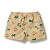 A pair of beige swim trunks with an all-over tropical print featuring palm trees, smiling suns, and blue fish, shown flat on a white background.