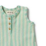 Close-up of a sleeveless baby romper or bodysuit with vertical mint green and off-white stripes, featuring a three-button henley neckline. The brand label reads 'wander + freely'.