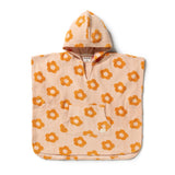 A hooded towel poncho in a light peach-beige color with an orange daisy pattern, featuring a front kangaroo pocket and a drawstring hood, shown flat on a white background.