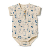 A short-sleeve baby bodysuit in cream with a blue cartoon animal and sun pattern, featuring a three-button henley neckline.
