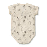 A short-sleeve baby bodysuit in cream with a black and gray whimsical print of children flying with balloons, shown flat against a white background.