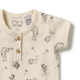 Close-up of a baby bodysuit in cream-colored cotton fabric with a black line art print of whimsical animals like bees, snails, and a bird on a hot air balloon. The bodysuit features a short button placket with wooden buttons.