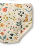 A close-up of a baby diaper or underwear piece with an all-over spring garden print on a cream background. The pattern features illustrated flowers, leaves, a rabbit, a bird, and small animals in muted green, orange, pink, and yellow tones.