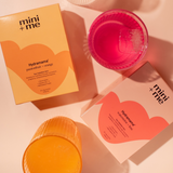 mini + me Hydramama packaging with pink and orange containers on a beige background