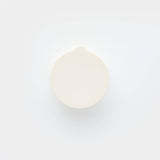 White soap bar on a light gray background