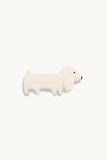 White dog-shaped toy on a white background