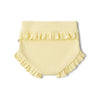 Yellow ruffled baby bloomers on a white background