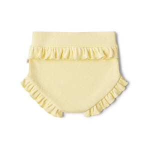 Yellow ruffled baby bloomers on a white background