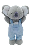 Plush toy koala in blue overalls on a white background